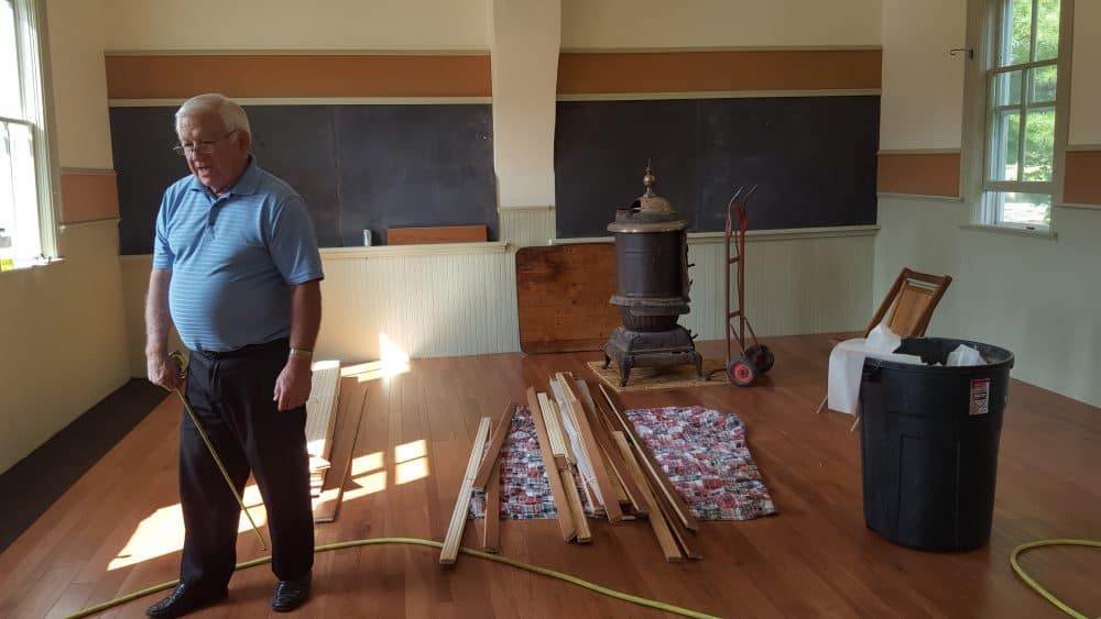 A board member restoring the school house after the fire