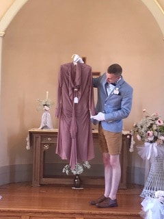 Curator Jesse Borlen presenting one of the bridal gowns